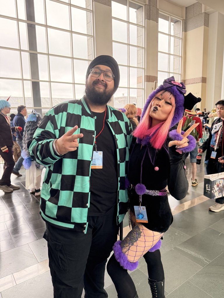Dave in costume with a person in purple and pink cosplay