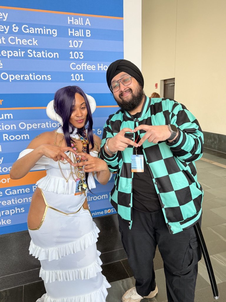 Dave in costume with a person in a white dress at a convention