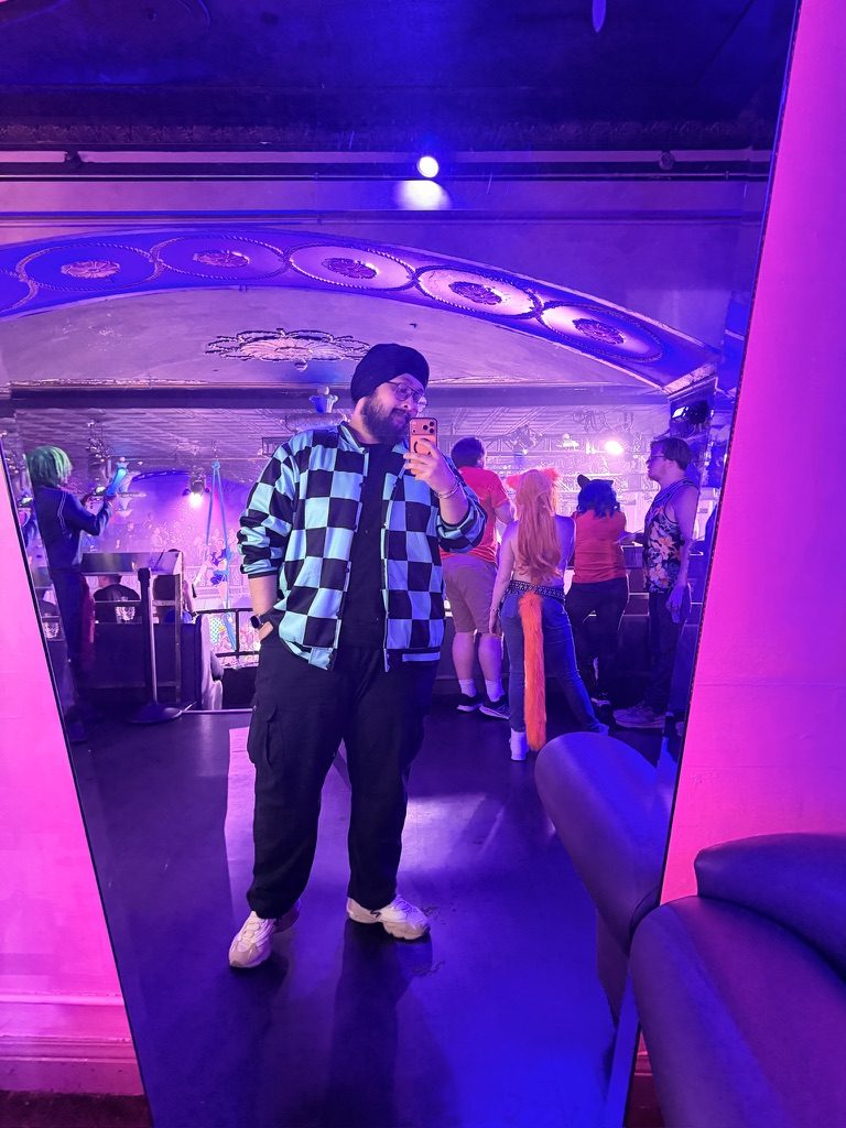 Dave in costume in a venue with purple lighting
