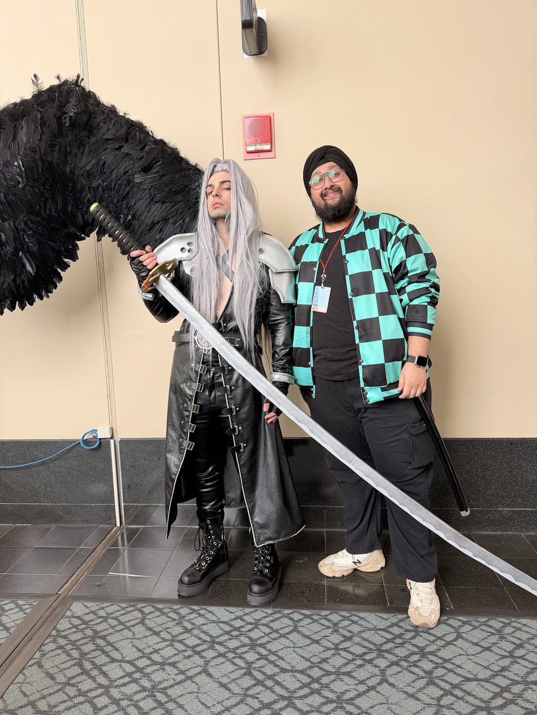 Dave in costume next to a cosplayer with long silver hair and a long sword