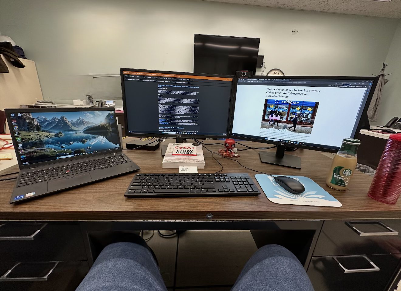 A work desk with a laptop and two monitors