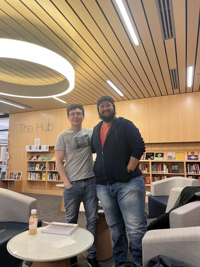 Dave and a friend standing in a library lounge